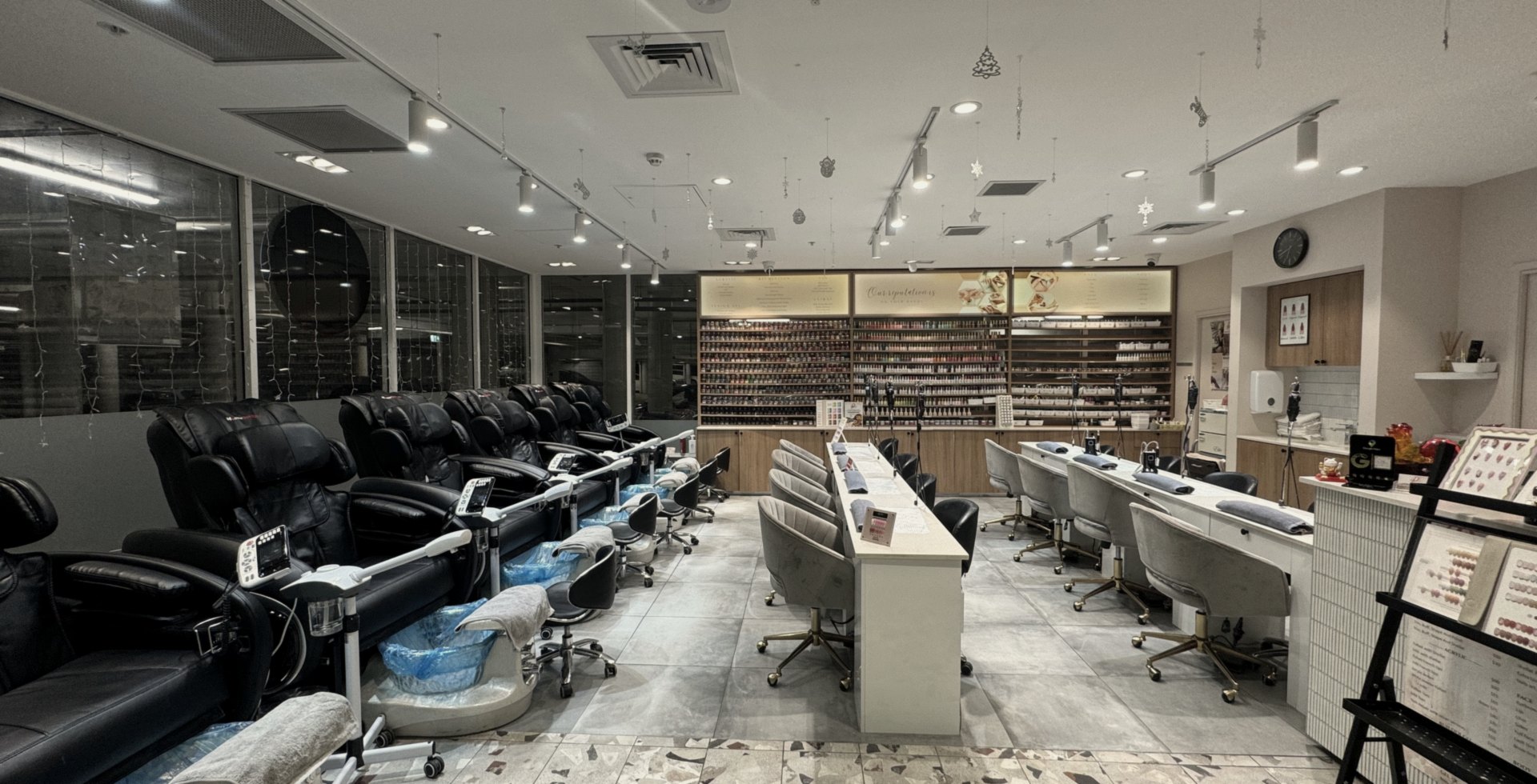 Inside ProfessioNail Narellan, pedicure chairs, manicure stations and the colour wall